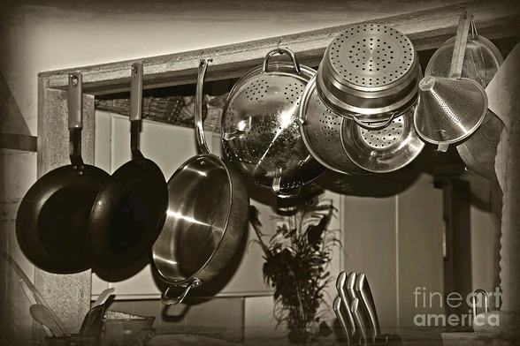 Photography in monochrome / sepia of an old retro style kitchen with hanging pots, pans and utensils. I just love this idea. Easy to reach and accessible without clogging up the kitchen cupboards. By Kaye Menner Photography.