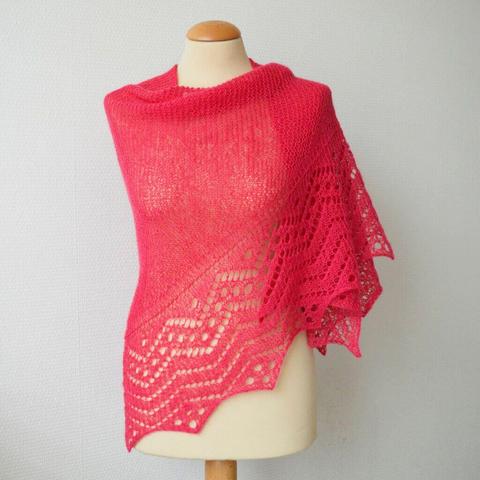 A pink knit shawl with a deep lace border, shown from the front on a mannequin against a white background.