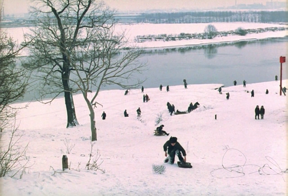 A scene from Mirror by Tarkovsky resembling "The Hunter in the Snow" by Pieter Bruegel: a boy is climbing up a snowy hill