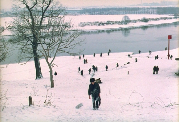 A scene from Mirror by Tarkovsky resembling "The Hunter in the Snow" by Pieter Bruegel: a boy is walking up a snowy hill