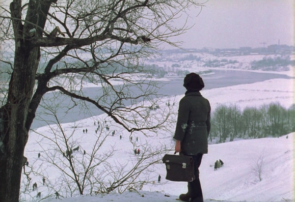 A scene from Mirror by Tarkovsky resembling "The Hunter in the Snow" by Pieter Bruegel: a boy is looking at the horizon on top of a snowy hill