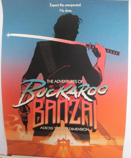 A poster for the movie "The Adventures of Buckaroo Banzai Across the 8th Dimension".

Additional text says "Expect the unexpected. He does."

The poster shows a man seen in silhouette against a blue and red background. He is holding a Samurai sword and a pistol, and he has an electric guitar strapped over his shoulder.