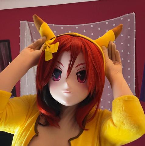 Kara Kig in a pikachu onsie with yellow tights, a yellow bow and black mary janes