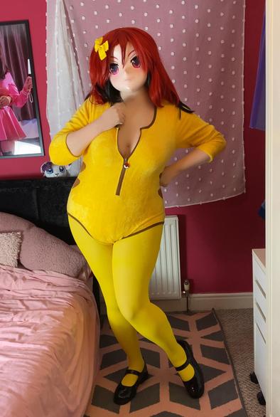 Kara Kig in a pikachu onsie with yellow tights, a yellow bow and black mary janes