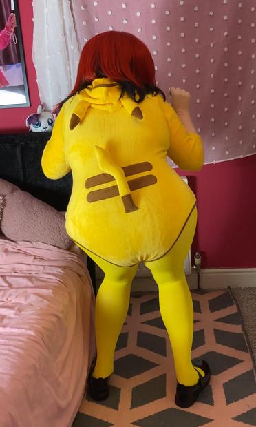 Kara Kig in a pikachu onsie with yellow tights, a yellow bow and black mary janes