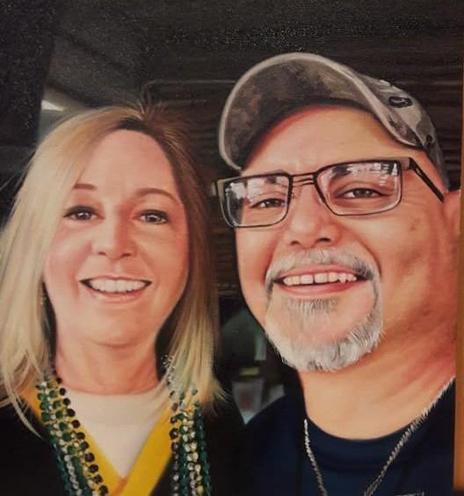a painting of a couple,seen from their chests up,  a man with a camo hat and a grey goatee and glasses, standing next to his wife, she has blonde straight hair she has beads on her and a green bay packers jersey, beaded necklaces around her neck n the team's colors