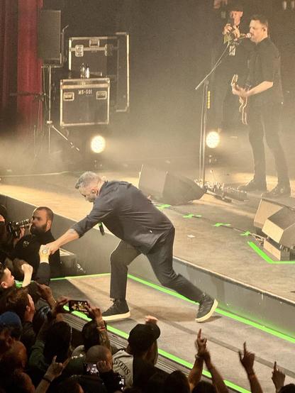 Lead singer of the Dropkick Murphys reaching for a fan at the show in Boston
