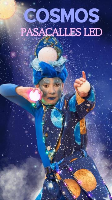 A performer in an extravagant blue costume with planetary patterns and glowing LED accents strikes a dynamic pose. With intense eye makeup and an intricate headpiece resembling a mini universe, they juggle illuminated balls, evoking the mystique of the cosmos