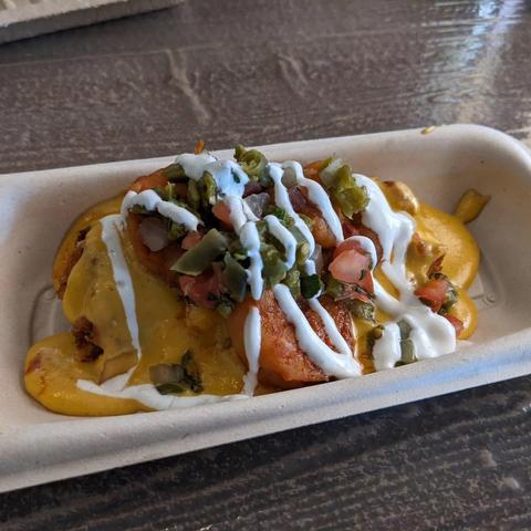 shrimp papas locas: cheddar-bacon potatoes with jalapeño cheese sauce and spicy shrimp featuring Tajín Chile Lime sauce 