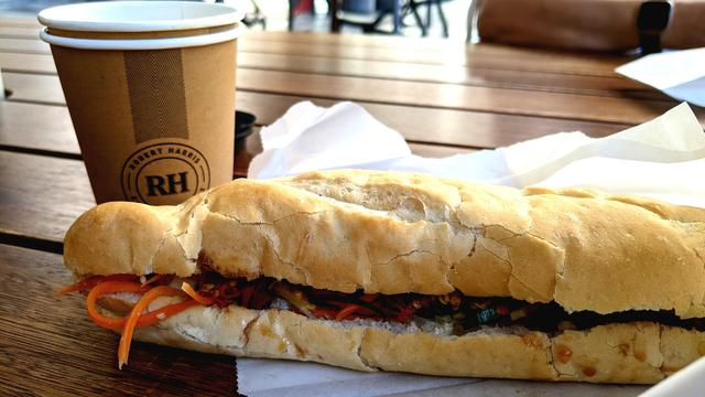 Banh Mi and coffee on a wooden table