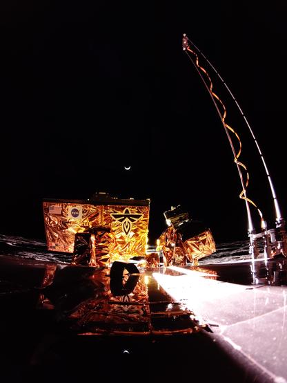 Blue Ghost lunar lander with a crescent Earth on the horizon. 