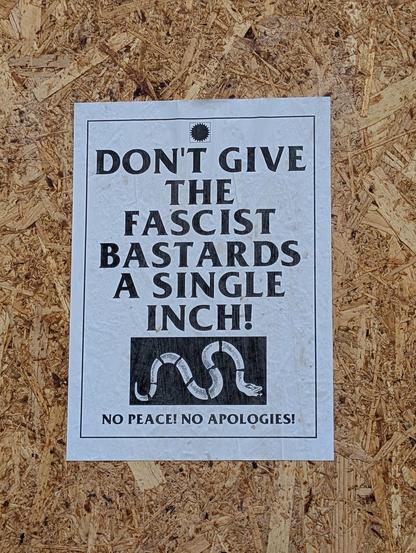 A sign that reads "Don't give the fascist bastards a single inch. No peace! No apologies!"
