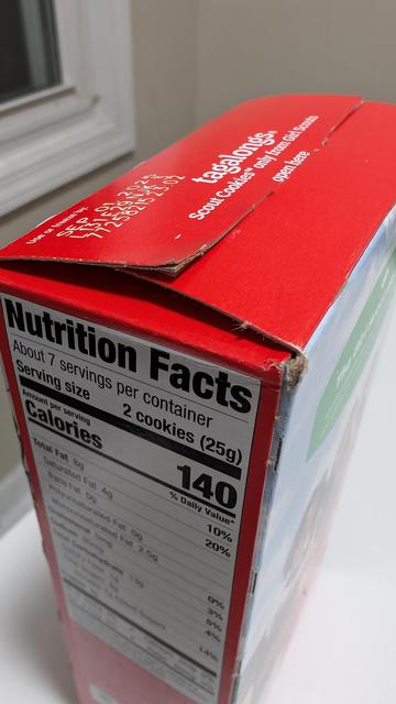 Top and side view of the "Nutrition Facts" label of a red box of Tagalong Girl Scout Cookies. The label indicates "about 7 servings per container," which is, of course, ridiculous when the contents are clearly meant to be consumed all at once in a single sitting. 

Right? 

RIGHT?!?