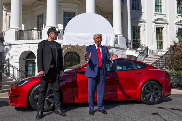 Elon Musk and Donald Trump try to sell Tesla cars on the White House lawn, 11 March 2025