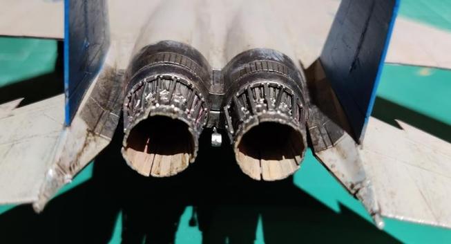 The view of the engine nozzles of a 1:72 scale model F-15E that has been weathered to look somewhat dirty.