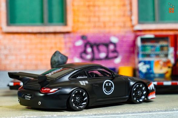 A right side of Old & New 997, Matte Black by Tarmac Works in 1:64 scale with 1:64 figure on AREA 164