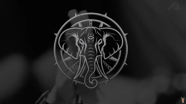 a transluscent logo of an elephant with spikes and a third eye in shades of grey in front of clapping hands 