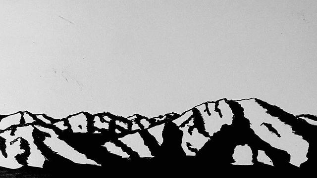 Ink drawing on paper of a mountain range. There is no color. 