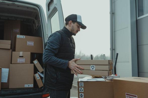 man loading or unloading boxes from a van