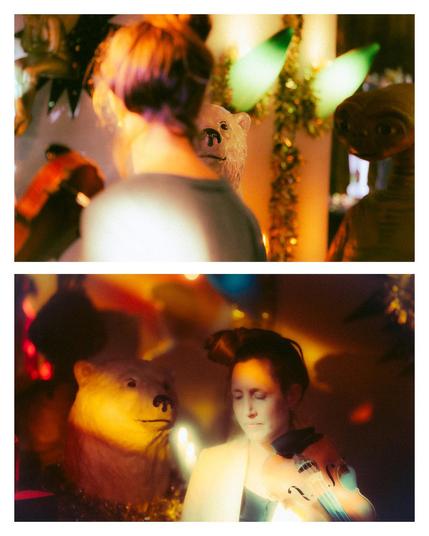 Two pictures of Laura in the colourful surroundings of the venue: there is a huge ice bear and lots of lights and decorations