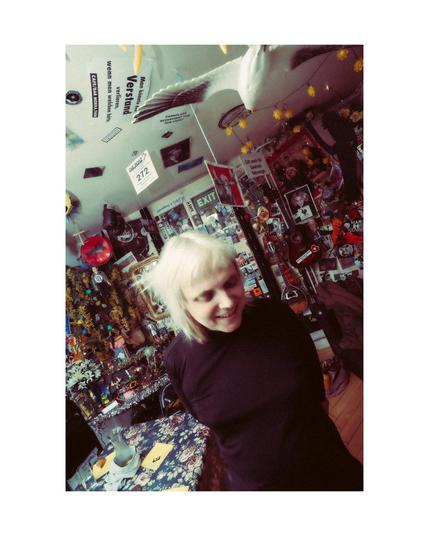 Hilke in the backstage, a very colourful place with a lot of ornaments and stickers