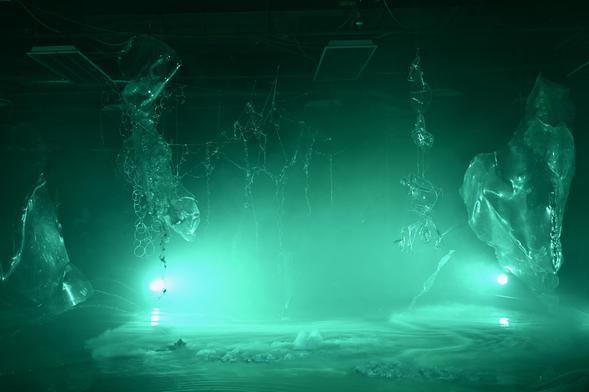 A green lit dripping drunk spider's cave