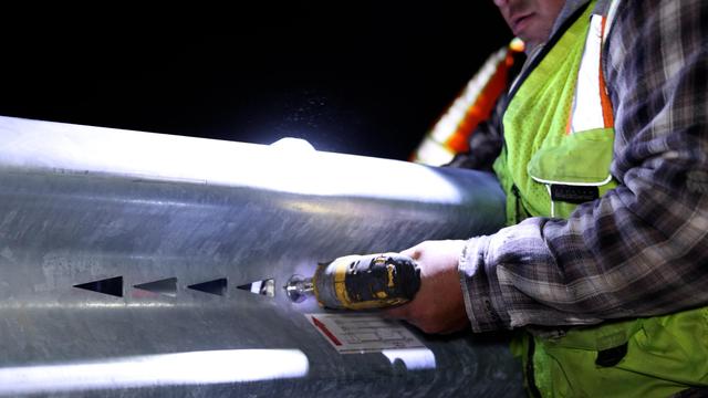 Installing the side thrie-beam panel on the side of the Delta crash cushion in Orange County, CA.