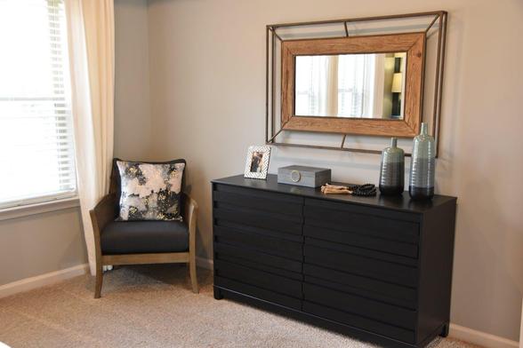 A stylish black dresser accompanied by a matching mirror, creating a cohesive and elegant look
