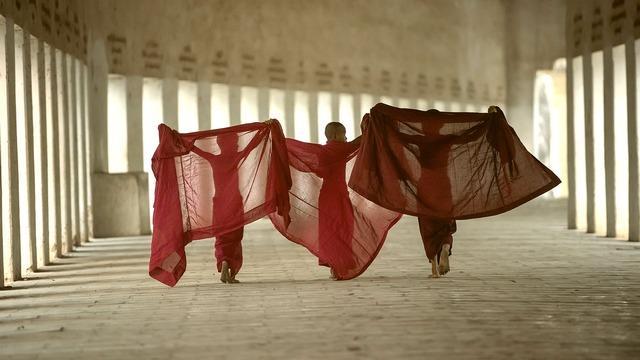 Monastics putting on robes.