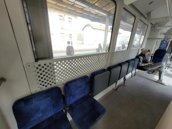 Row of 9 foldable seats along 3 windows with straps to attach bicycles.
