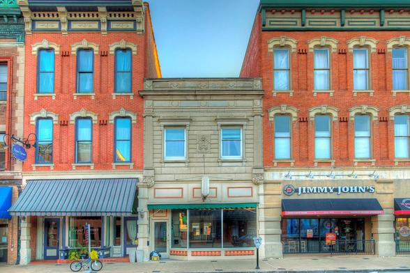 Historic brick buildings line a quaint street, showcasing a mix of architectural styles