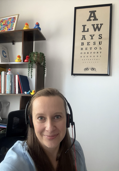 A woman with headset is smiling