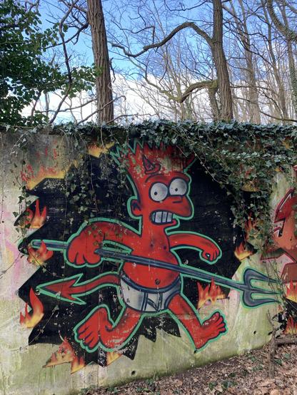 A vibrant graffiti mural depicting a cartoonish character with fiery red skin, running and holding a pitchfork. The character is styled in a playful manner and is surrounded by flames, set against a textured, weathered wall covered with ivy.