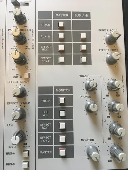 Close-up of knob caps an buttons in the Monitor section of an Akai MG614 multitrack cassette recorder.