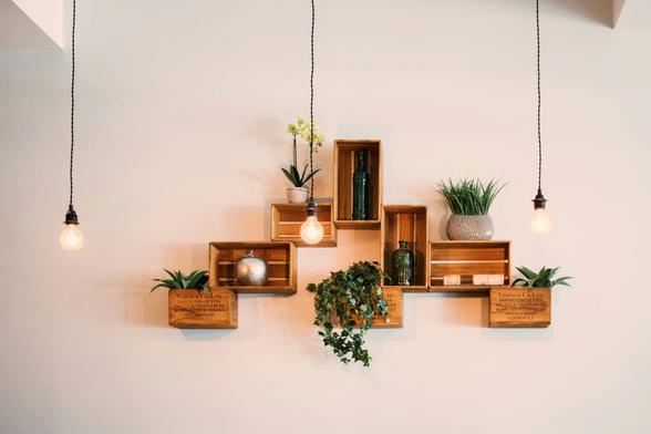 A room showcasing a decorative wall hanging filled with lush plants, contributing to a serene and inviting atmosphere