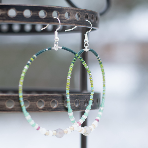 Green beaded earrings with purple accent beads