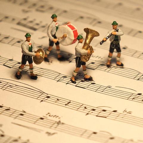 Hummel style marching band musicians on sheet music