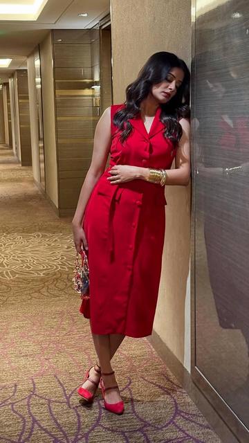 Priyamani's appearance at the OTT Play Awards was nothing short of spectacular. She donned a bold red Emblaze MB dress with sharp collared lapels and a belted waist, highlighting her elegant silhouette. The ensemble was accessorized with a YV Brand scarlet drawstring pouch and statement golden jewelry, adding a touch of sophistication. Her makeup featured bold red lips and subtle smokey eyes, while her hair was styled in soft waves, completing her glamorous look.
