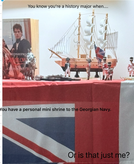 Model ship with model sailors and soldiers