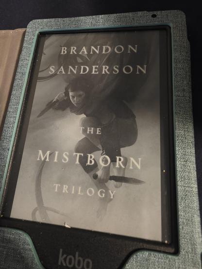 Kobo e-reader showing the cover of the Mistborn Trilogy