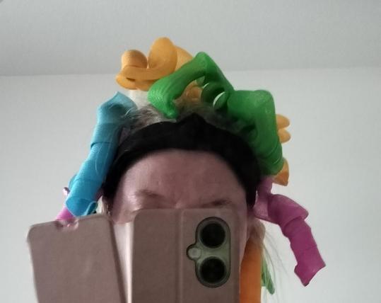 Colorful platics spiral curlers all over my head lol 