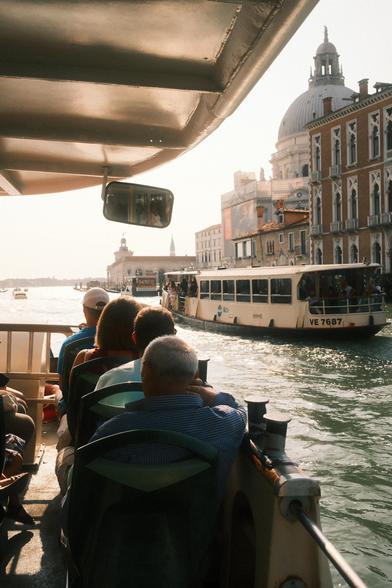 People commuting by boat on Venice Grand Canal