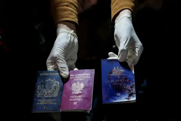 A man displays blood-stained British, Polish, and Australian passports after the deadly Israeli air strike on April 1, 2024 [Abdel Kareem Hana/AP Photo]