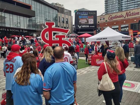 Crowd gathers outside the park in Cardinal red, white, and light blue for the Saint Louis Cardinals’ 2025 MLB opening game.