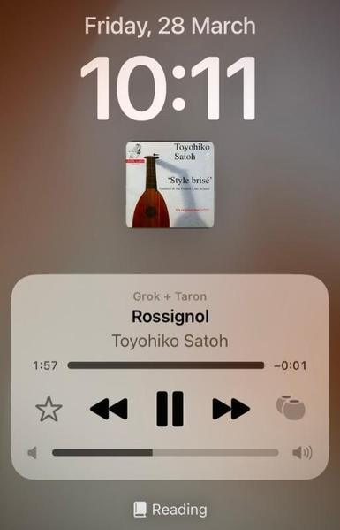 The screen of a mobile phone shows the date Friday, 28 March at 10:11, the cover of a Toyohiko Satoh's lute album and the current track (Rossignol) playing