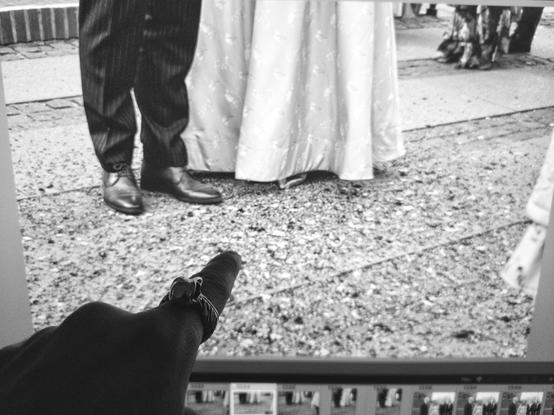 A wedding couples feet surrounded by rose petals