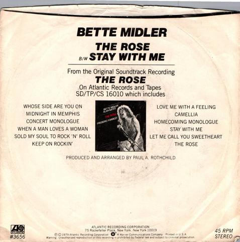 This is the back cover of the 45 RPM single of music artist, Bette Midler's song, "The Rose". It displays the same photo as from the front only postage stamp size and lists 12 tracks from "The Rose" Movie Soundtrack. 
