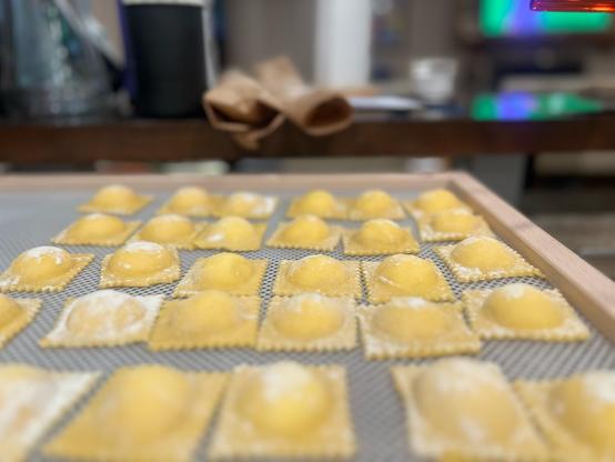 Ravioli drying on a pasta net. 
