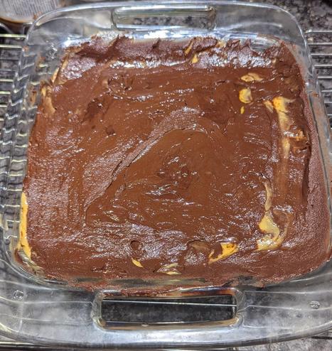 A messy layer of melted semisweet chocolate added to the custard layer