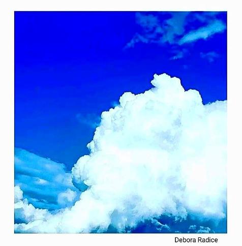 A blue and light blue sky with flully clouds.